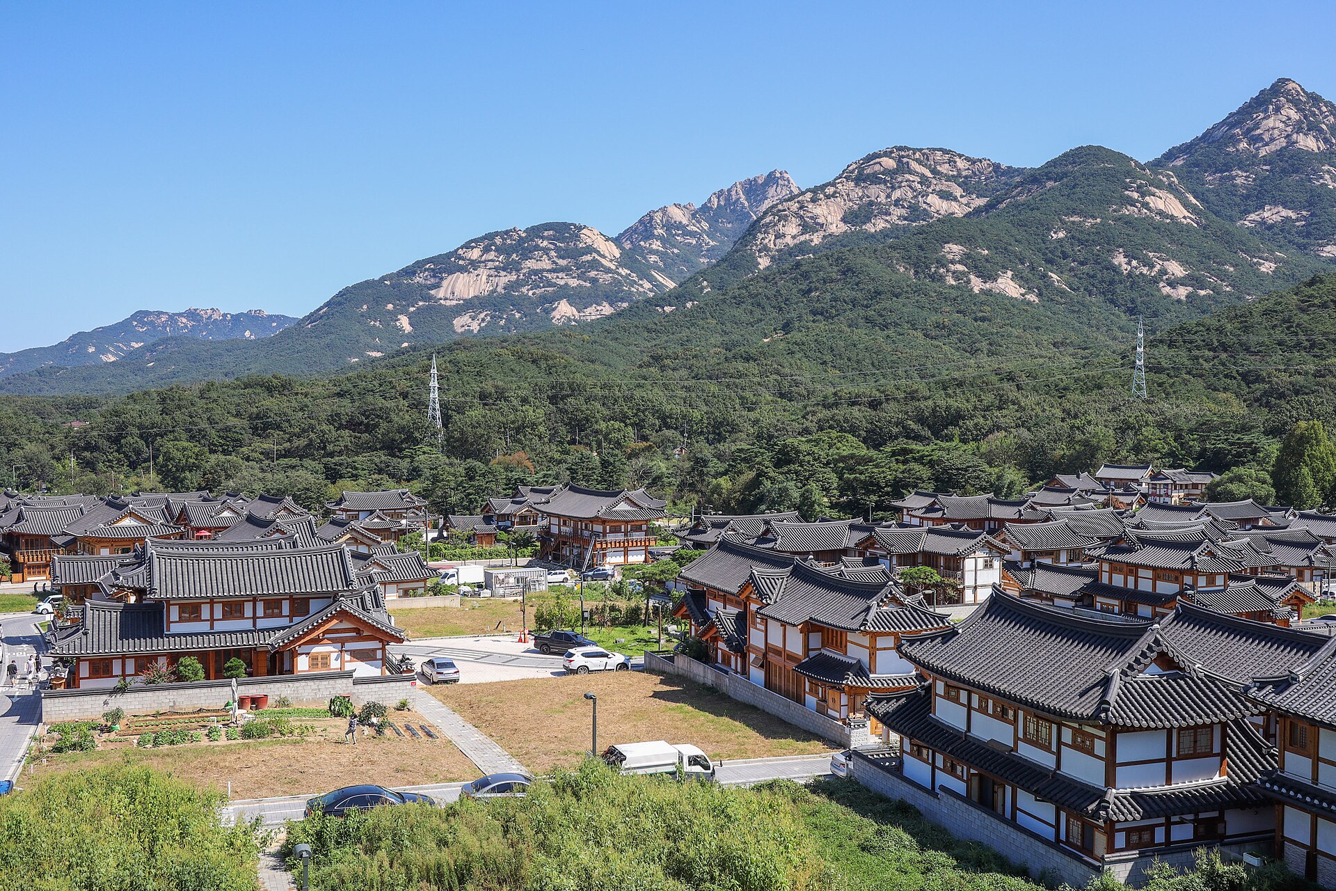 Eunpyeong Hanok Village rooftops beneath the rocky peaks of Bukhansan Mountain